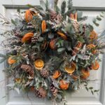 Heavily textured orange wreath and fresh foliage