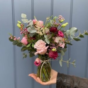Jam jar full of pink flowers