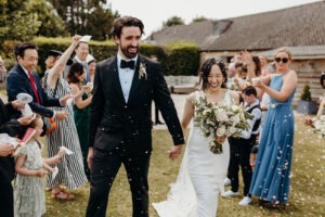 Bride and Groom just married being showered in confetti