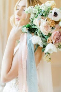 bouquet and bride holding her flowers with personalised ribbons