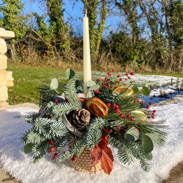 Festive table florals with tapered candle