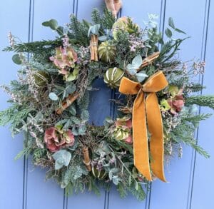 Beautifully textured wreath with dried hydrangea, cinnamon and limes with a golden velvet ribbon
