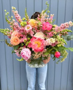 Peach, pink and coral vase display filled with seasonal blooms