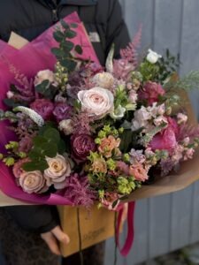 Bath florist holding pink opulence valentine bouquet of flowers