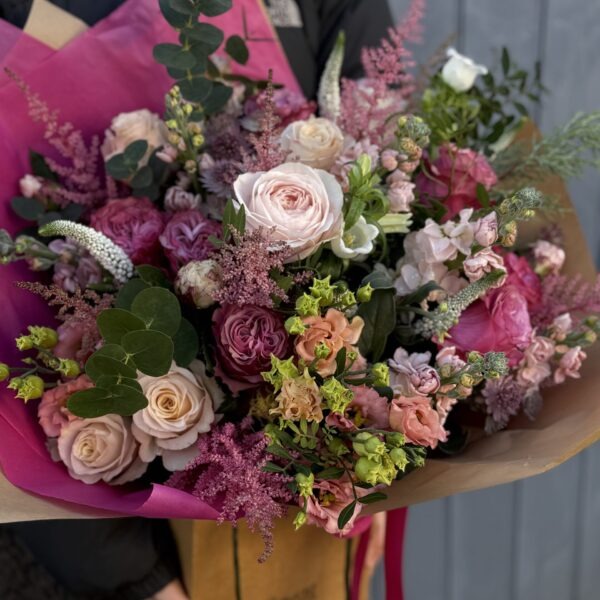 Bath florist holding pink opulence valentine bouquet of flowers