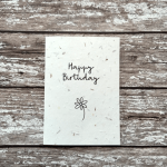 White birthday card with simple flower on - plantable wild flower seeds.