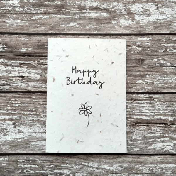 White birthday card with simple flower on - plantable wild flower seeds.