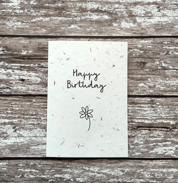 White birthday card with simple flower on - plantable wild flower seeds.