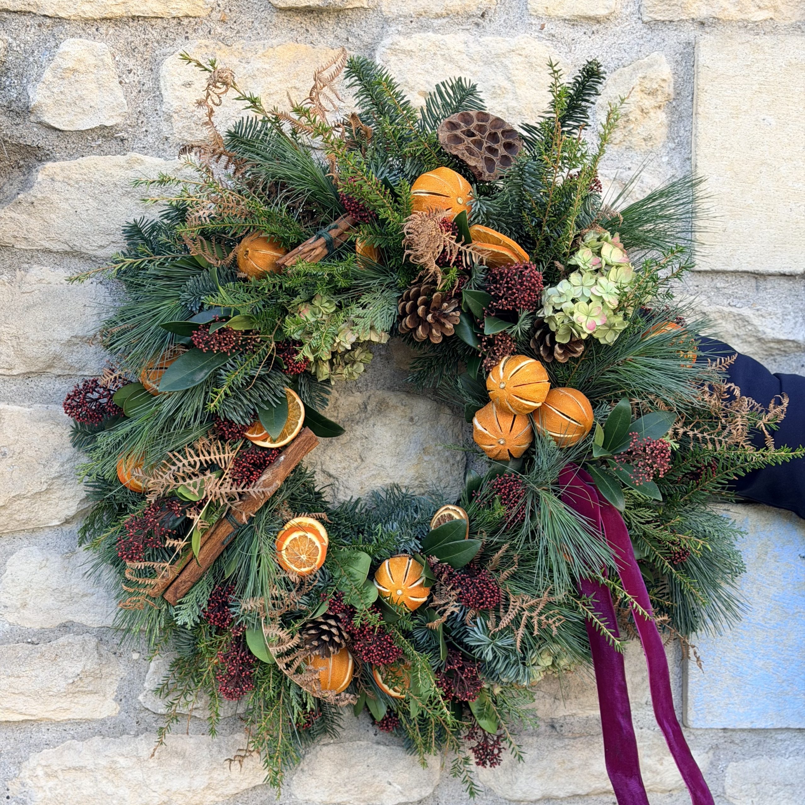 Christmas wreath filled with fruits, cinnammon and foliages